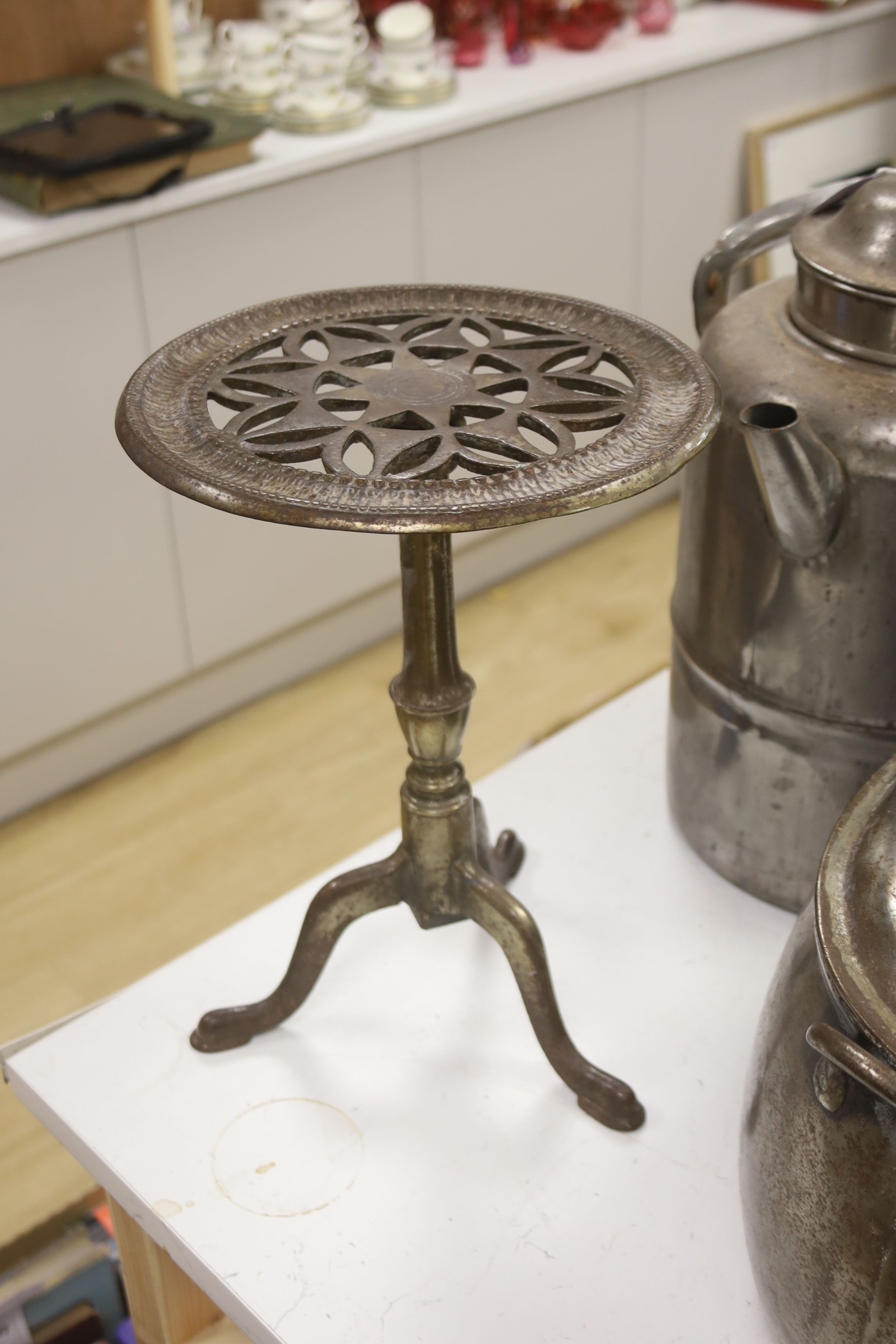 A metal trivet, a lidded pot and a kettle, tallest 43cm